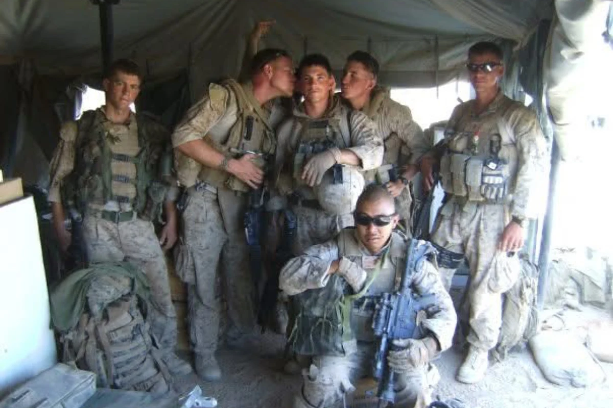 Justin Cox with his Marine squad in a tent on deployment